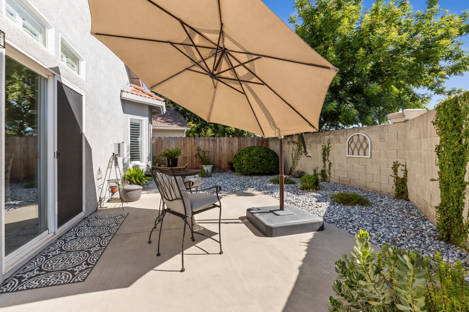 3300 Spring Garden Drive Turlock, CA 95382 - Photo 27 of 34 a view of a patio with table and chairs under an umbrella