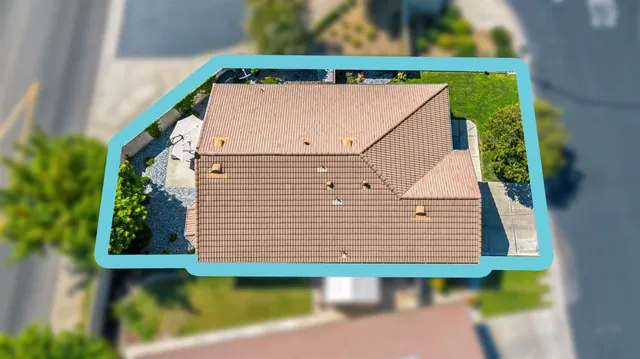 an aerial view of a house with a yard and sitting space