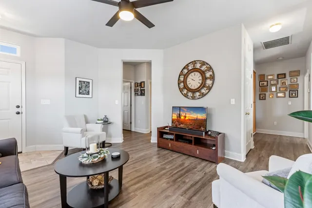 a living room with furniture a fireplace and a window