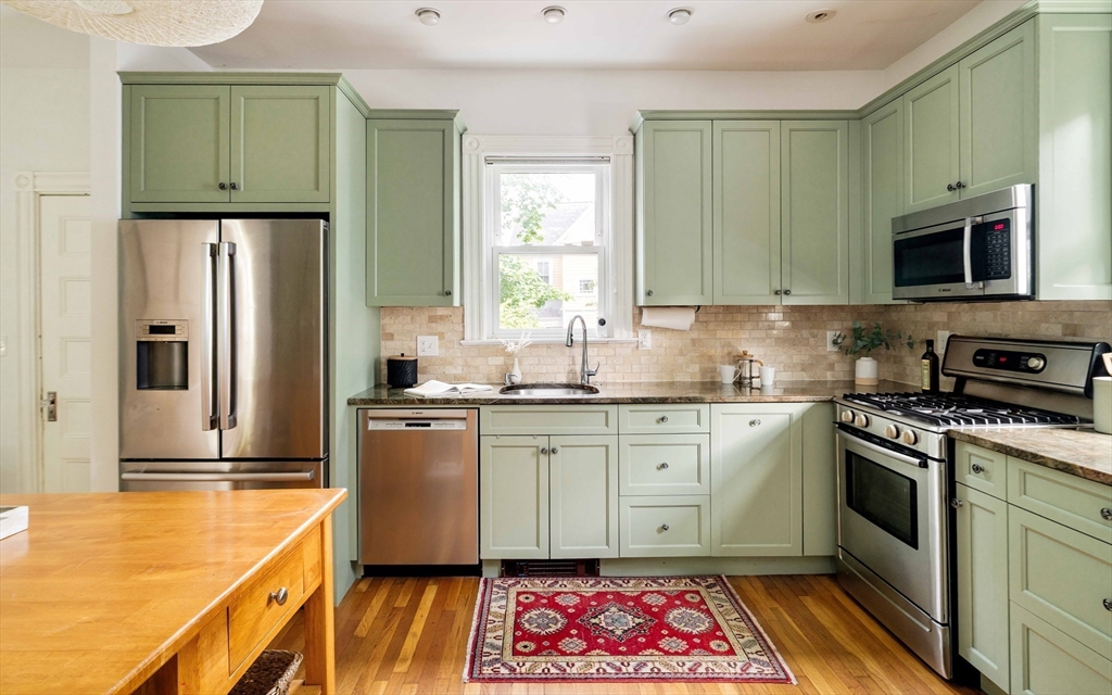 52 Walter Street Boston, MA 02131 - Photo 12 of 31 a kitchen with stainless steel appliances granite countertop a stove a sink and a refrigerator