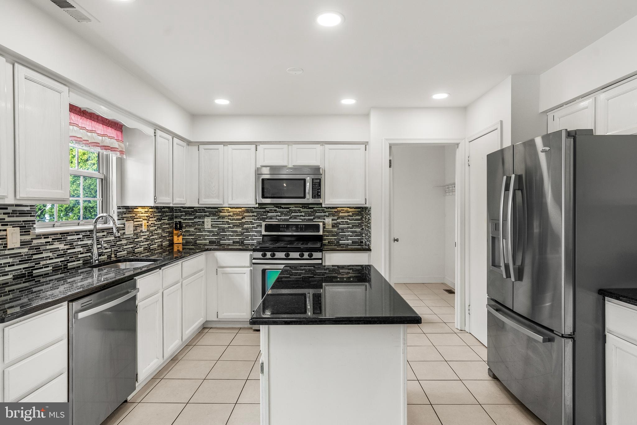 10 Winfield Circle Sewell, NJ 08080 - Photo 3 of 37 a kitchen with stainless steel appliances a stove a sink and a refrigerator