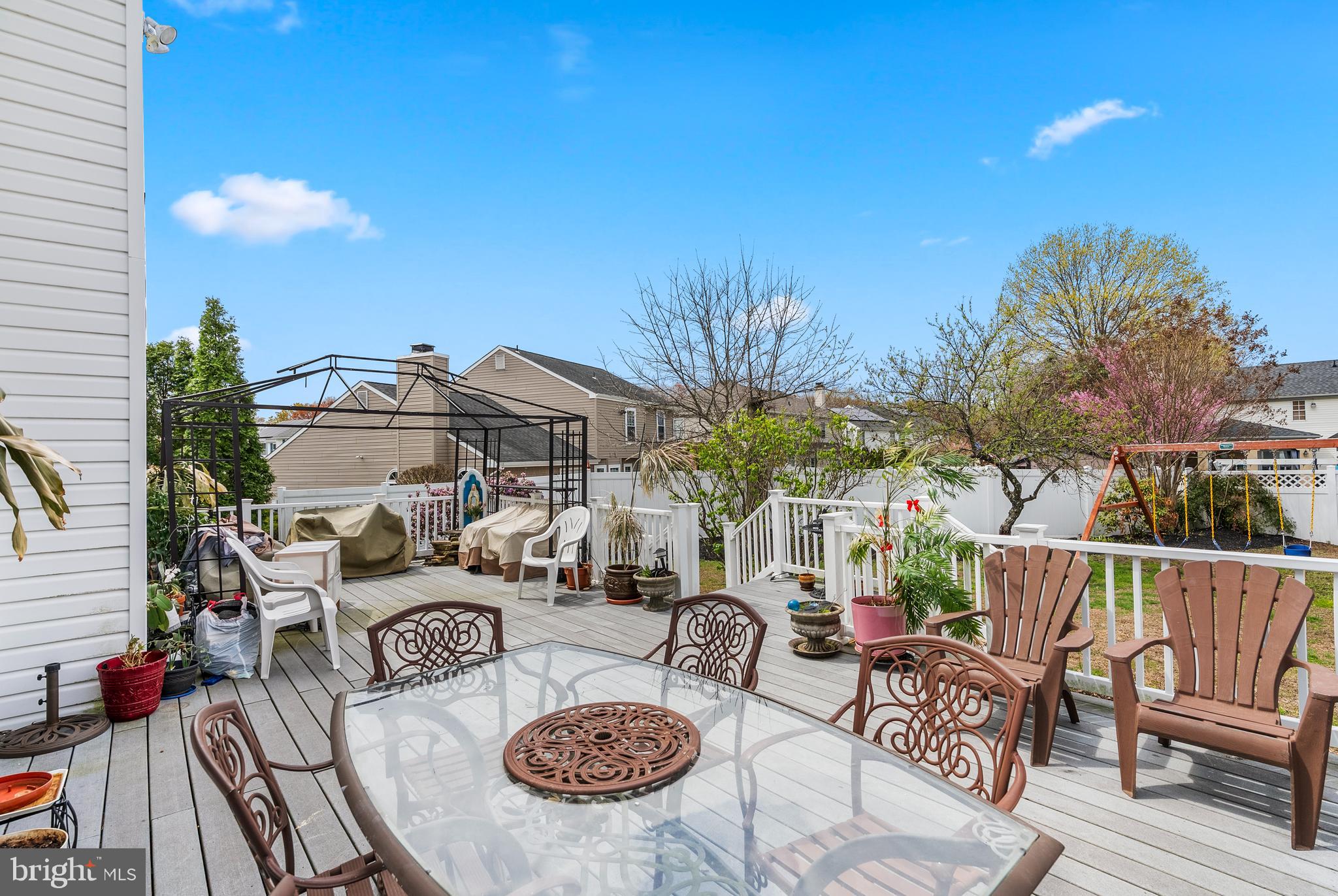 10 Winfield Circle Sewell, NJ 08080 - Photo 31 of 37 a view of a patio with couches table and chairs under an umbrella with wooden floor