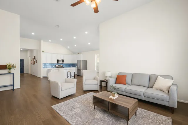 a living room with furniture and kitchen view