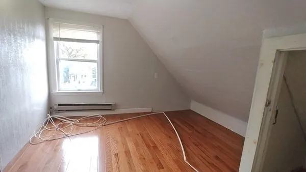 a view of a room with rack on the wall and a window