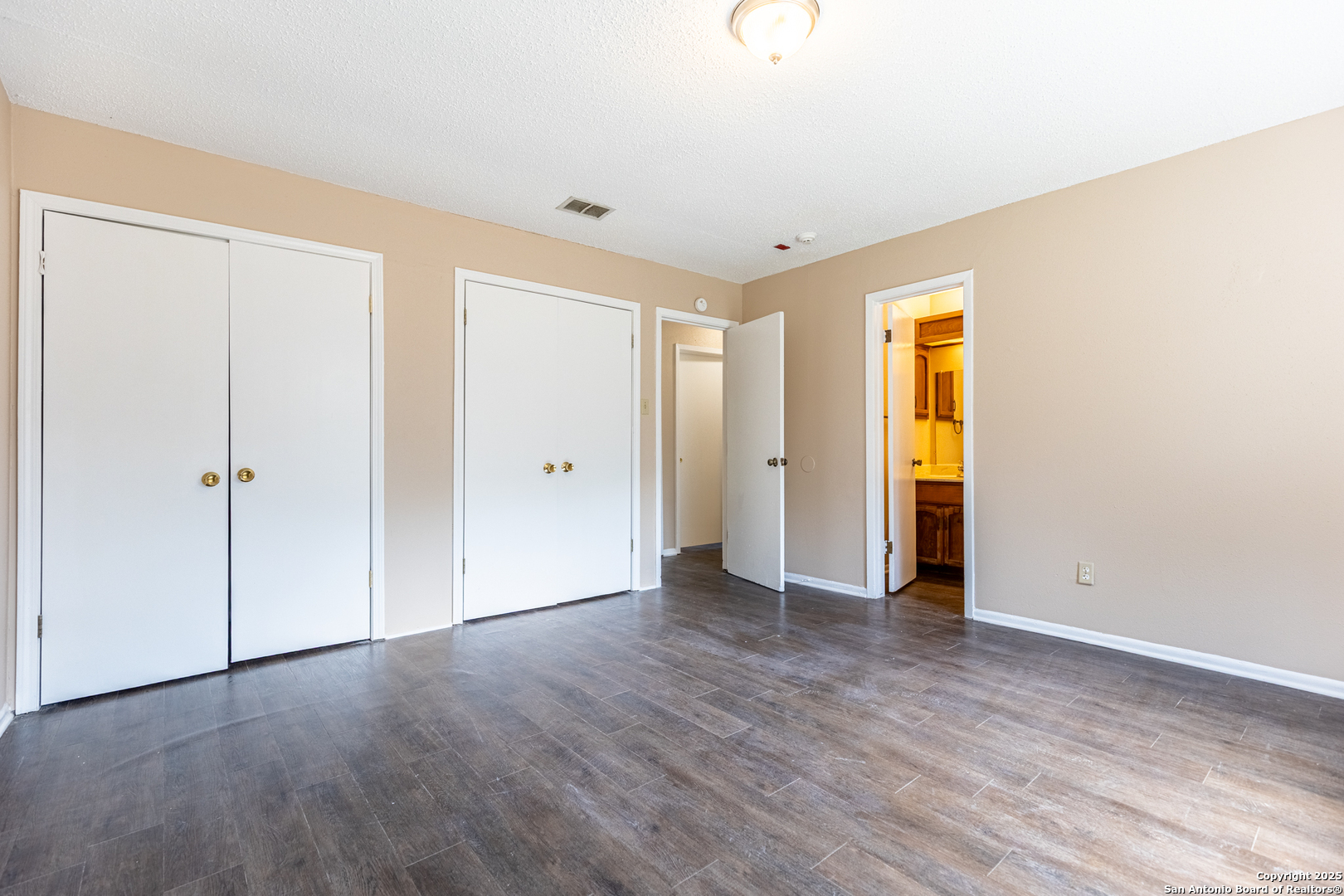 5814 Pineway Street San Antonio, TX 78247 - Photo 13 of 18 a view of an empty room with wooden floor