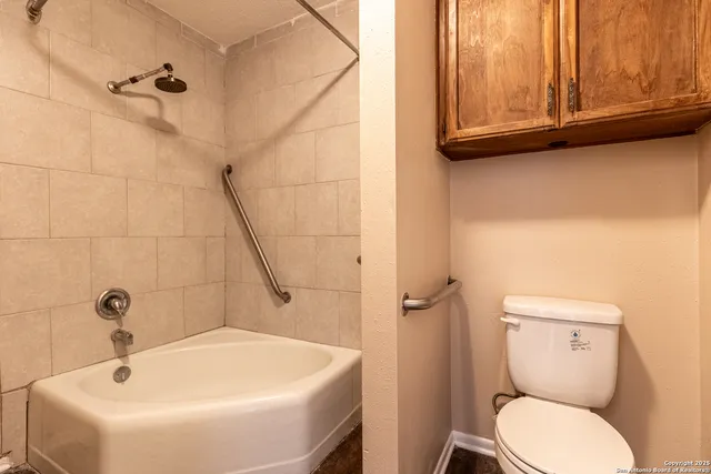 a bathroom with a sink a toilet and bathtub