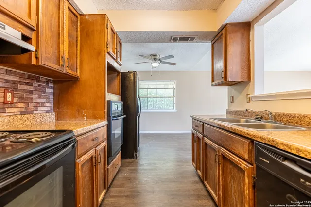 a kitchen with a sink stove and cabinets