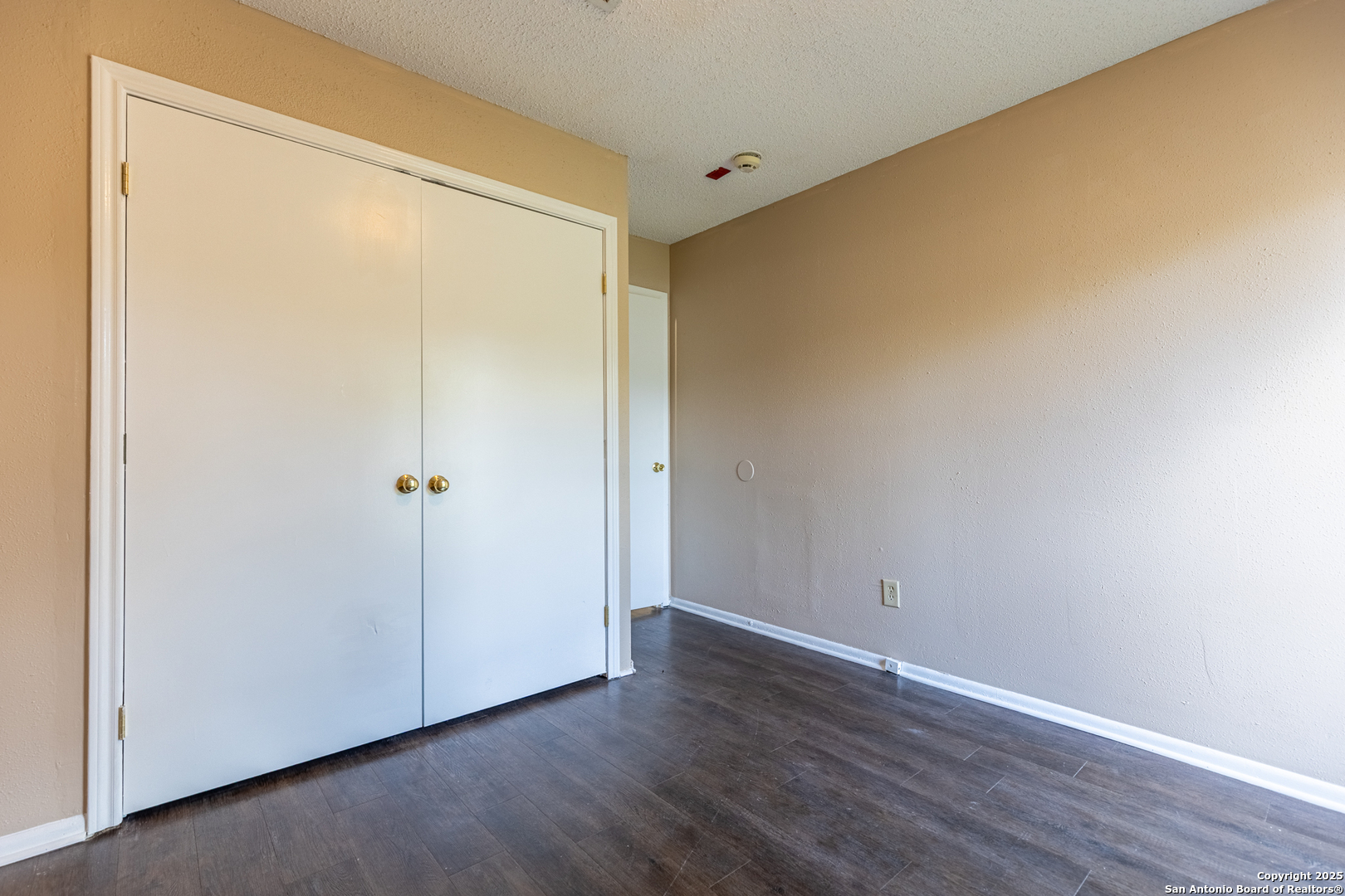 5814 Pineway Street San Antonio, TX 78247 - Photo 10 of 18 a view of an empty room with wooden floor and a window