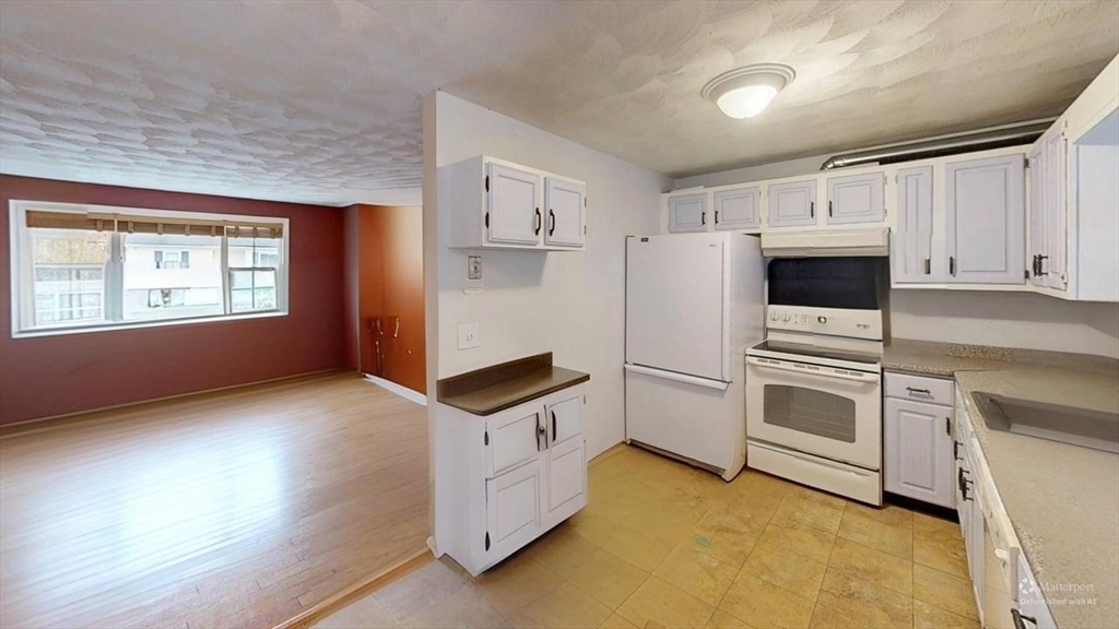 5 Douglas Lane Wareham, MA 02538 - Photo 7 of 15 a kitchen with granite countertop white cabinets and white appliances