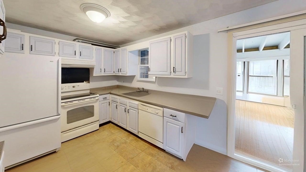5 Douglas Lane Wareham, MA 02538 - Photo 8 of 15 a kitchen with granite countertop white cabinets and white appliances