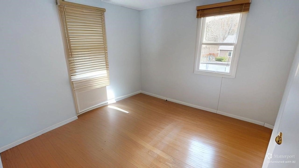 5 Douglas Lane Wareham, MA 02538 - Photo 10 of 15 an empty room with wooden floor and a window