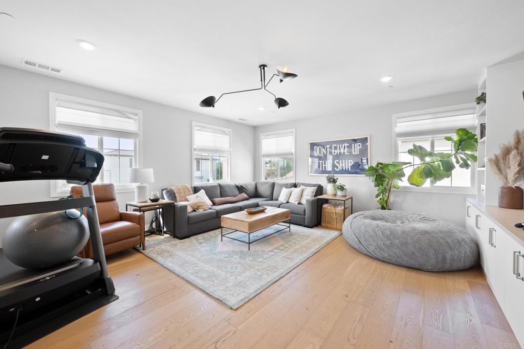 1211 Tesoro Place Vista, CA 92081 - Photo 21 of 57 a living room with furniture and a flat screen tv