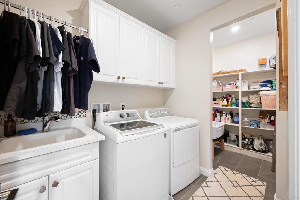 1211 Tesoro Place Vista, CA 92081 - Photo 31 of 57 a view of walk in closet with clothes and shoes