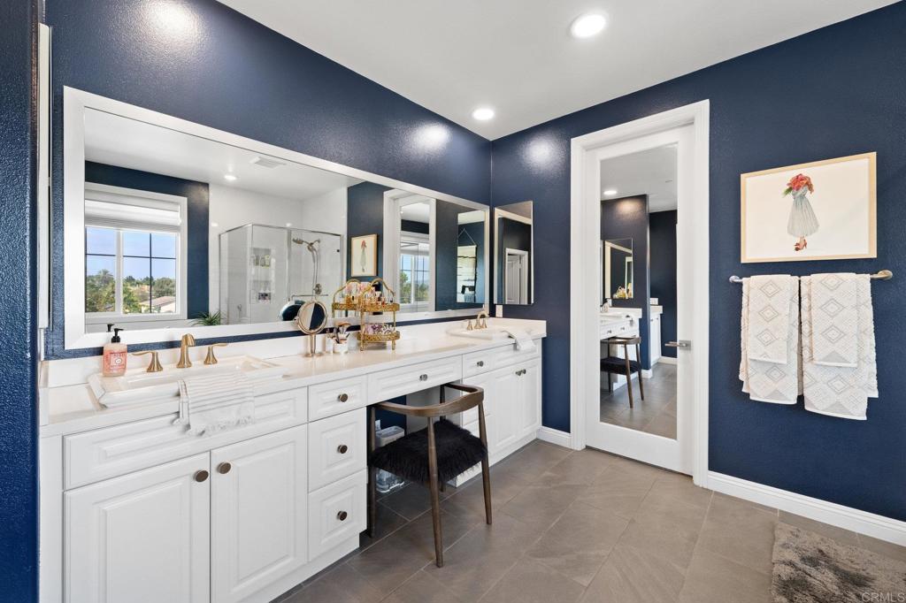 1211 Tesoro Place Vista, CA 92081 - Photo 36 of 57 a bathroom with a double vanity sink mirror and shower