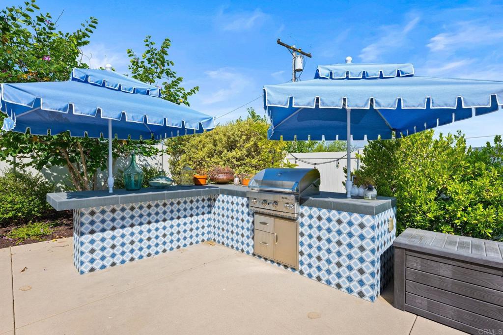 1211 Tesoro Place Vista, CA 92081 - Photo 40 of 57 a view of a chairs and table in the backyard
