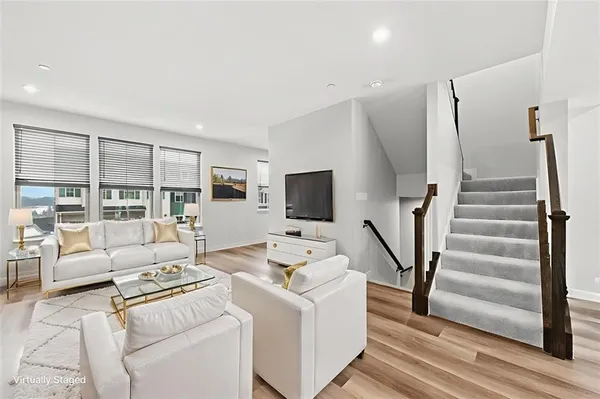 a view of entryway with wooden floor and stairs