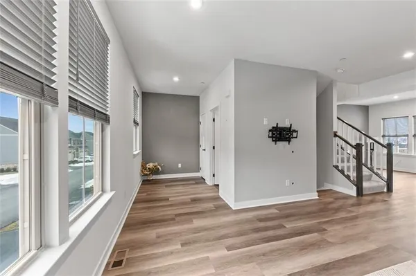 a view of wooden floor and a window in a room