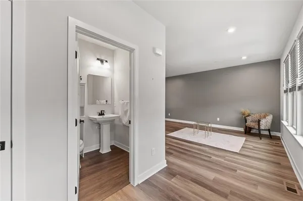 a bathroom with a sink a toilet and mirror