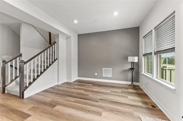 a living room with furniture kitchen view and a large window
