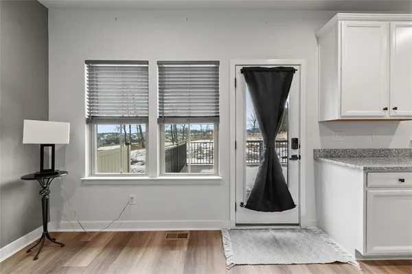 a kitchen with white cabinets and sink