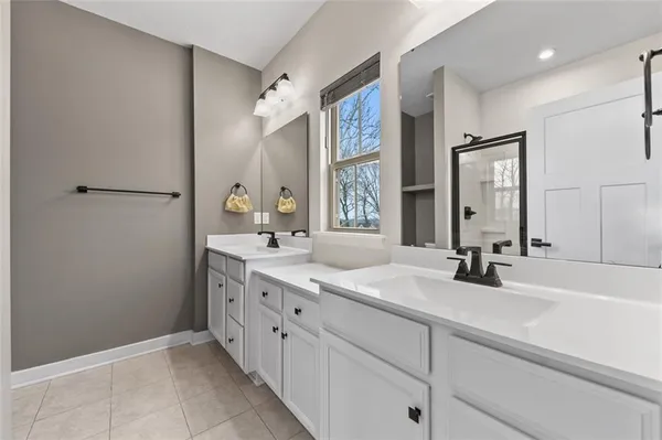 a bathroom with a sink vanity and mirror