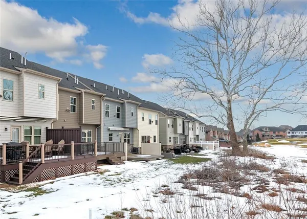 a view of a house with snow on the road