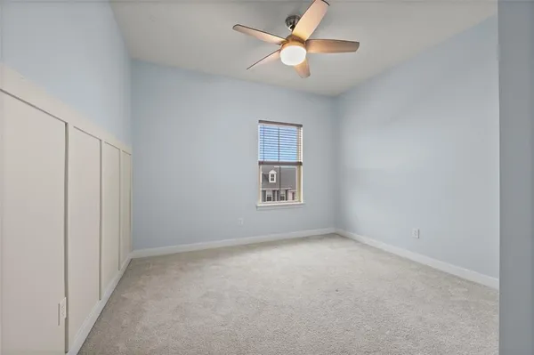 an empty room with a ceiling fan