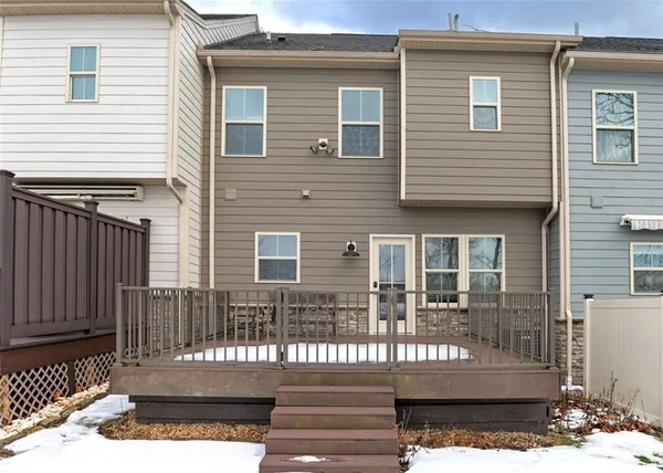 a view of a house with a wooden deck