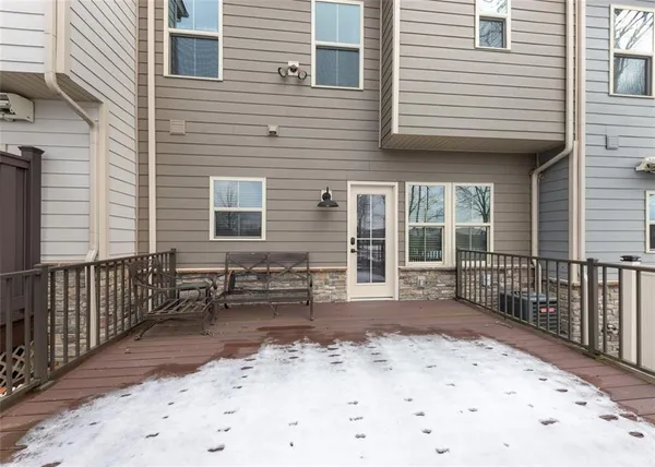 a view of a house with a wooden fence