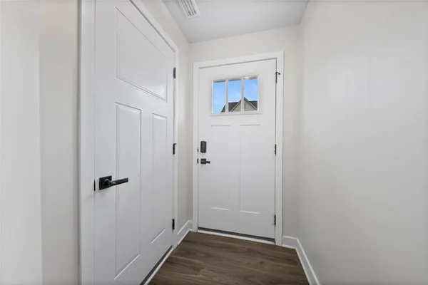 a view of a hallway with wooden floor and staircase