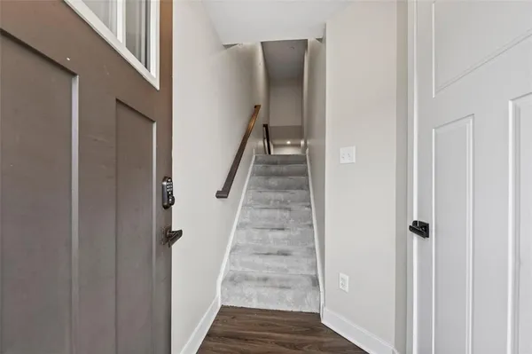 a view of entryway with wooden floor and stairs