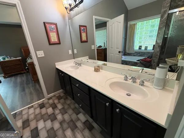 a bathroom with a shower and a mirror