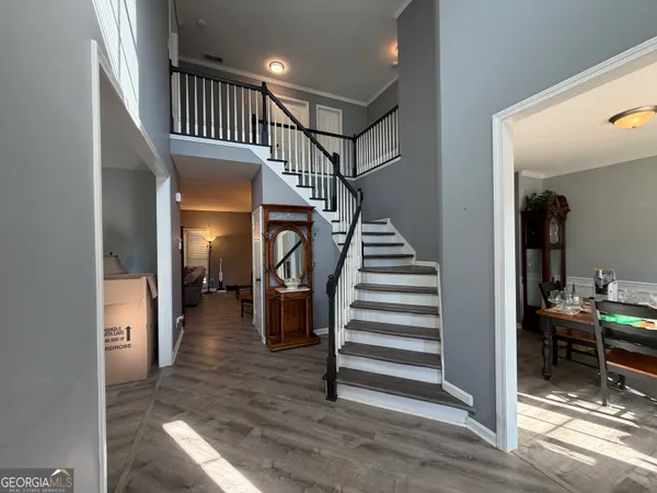 a view of entryway and hall with wooden floor