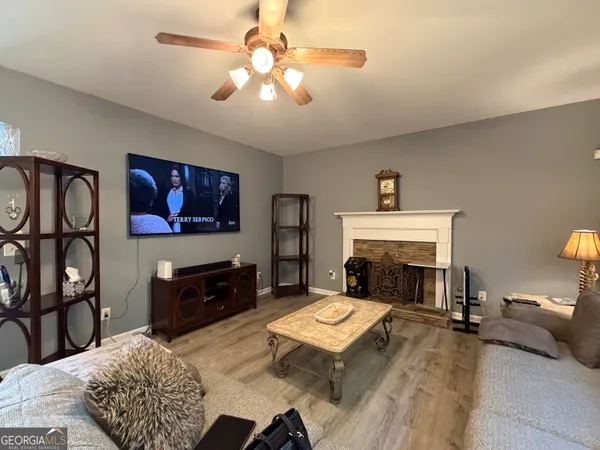 a living room with furniture flat screen tv and a fireplace