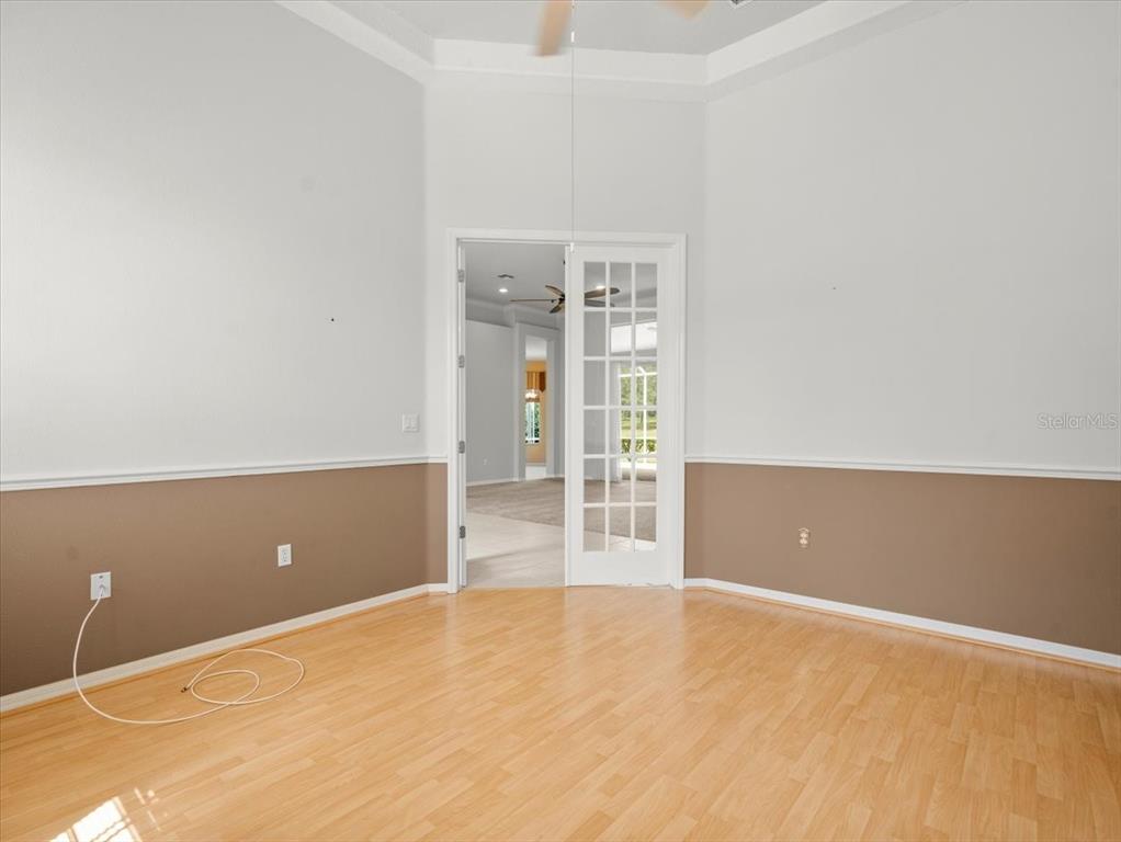9037 Penelope Drive Weeki Wachee, FL 34613 - Photo 16 of 60 a view of an empty room with wooden floor and windows