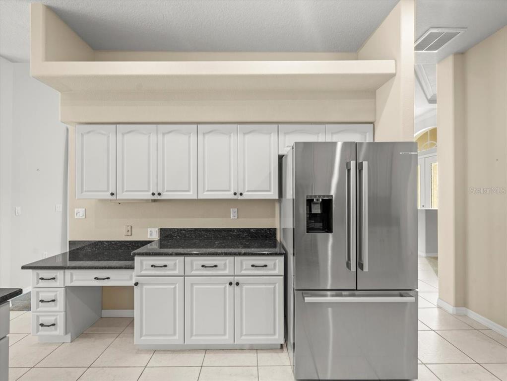 9037 Penelope Drive Weeki Wachee, FL 34613 - Photo 22 of 60 a kitchen with stainless steel appliances granite countertop a refrigerator sink and cabinets