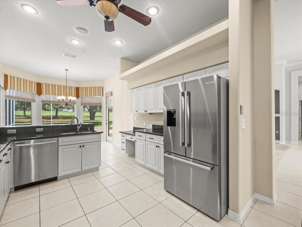 9037 Penelope Drive Weeki Wachee, FL 34613 - Photo 23 of 60 a kitchen with stainless steel appliances granite countertop a refrigerator and microwave
