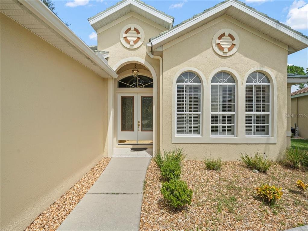 9037 Penelope Drive Weeki Wachee, FL 34613 - Photo 3 of 60 a view of a brick house with potted plants
