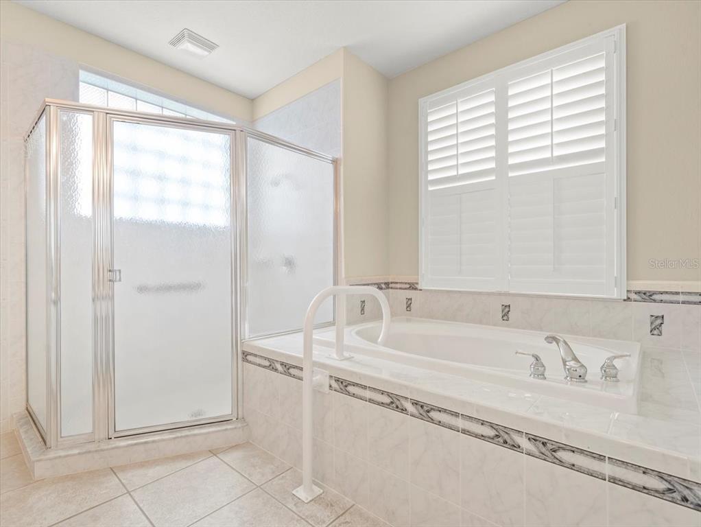 9037 Penelope Drive Weeki Wachee, FL 34613 - Photo 33 of 60 a bathroom with a tub sink and mirror