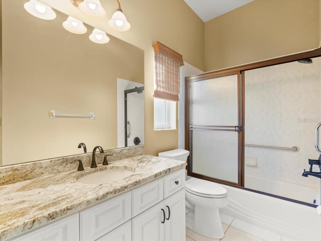 9037 Penelope Drive Weeki Wachee, FL 34613 - Photo 37 of 60 a bathroom with a granite countertop sink toilet and shower