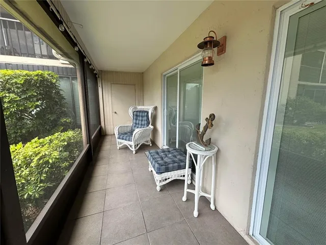a balcony view with a couch and wooden floor