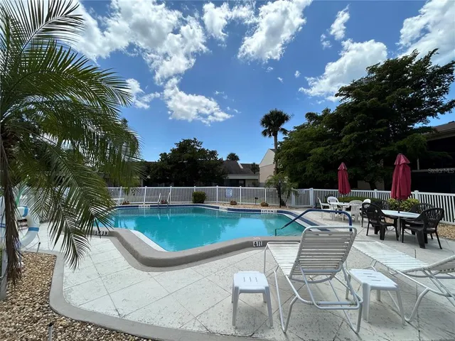 a view of a swimming pool with outdoor seating