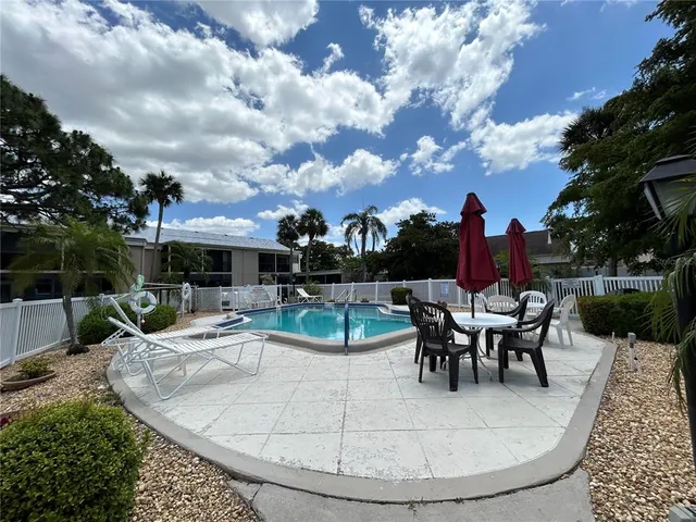 a view of a room with wooden floor and a bench