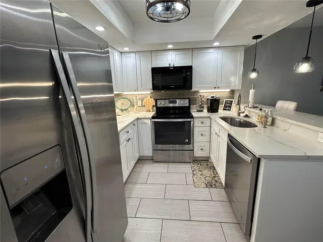 a kitchen with a sink stainless steel appliances and cabinets
