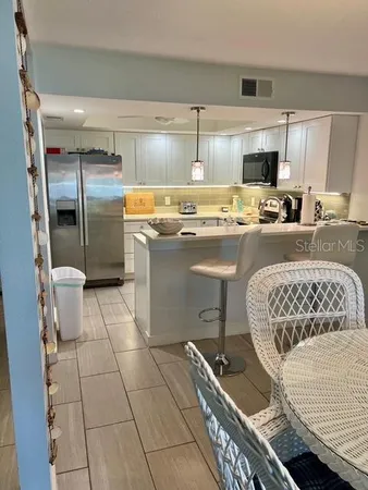 a kitchen with a sink a stove a refrigerator and cabinets