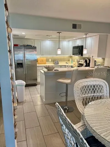 a kitchen with a sink a stove a refrigerator and cabinets