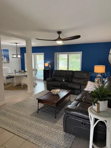 a living room with furniture and a potted plant
