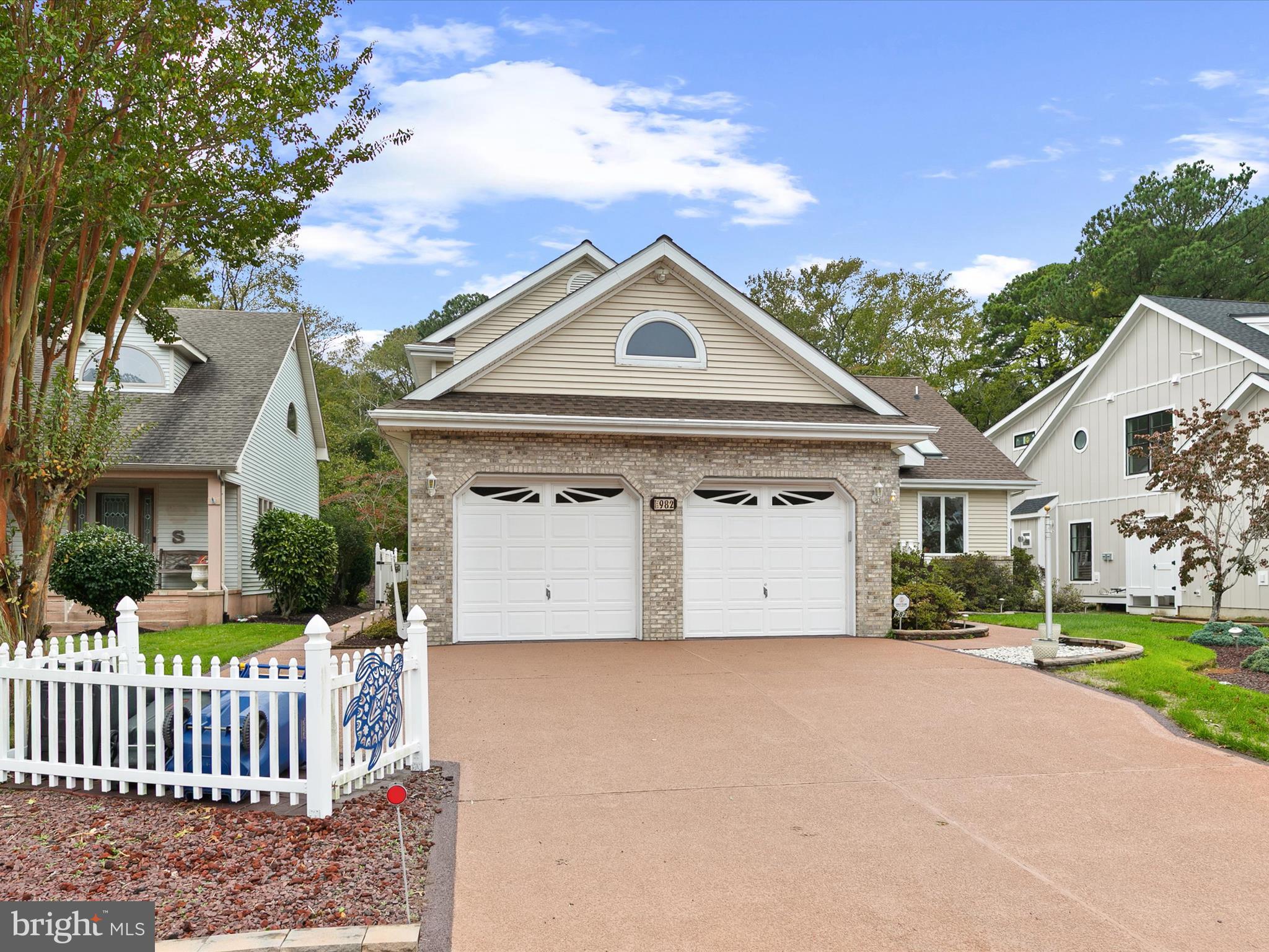 982 Turtle Drive Bethany Beach, DE 19930 - Photo 3 of 73 a front view of a house with garden