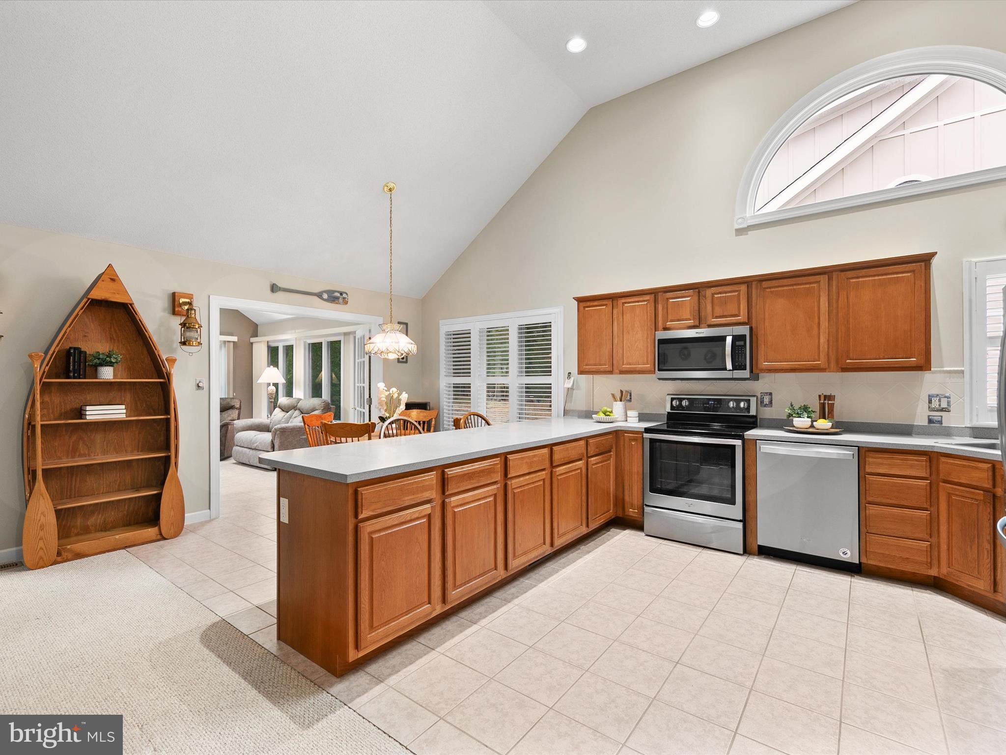 982 Turtle Drive Bethany Beach, DE 19930 - Photo 5 of 73 a kitchen with stainless steel appliances granite countertop a stove top oven a sink dishwasher and cabinets