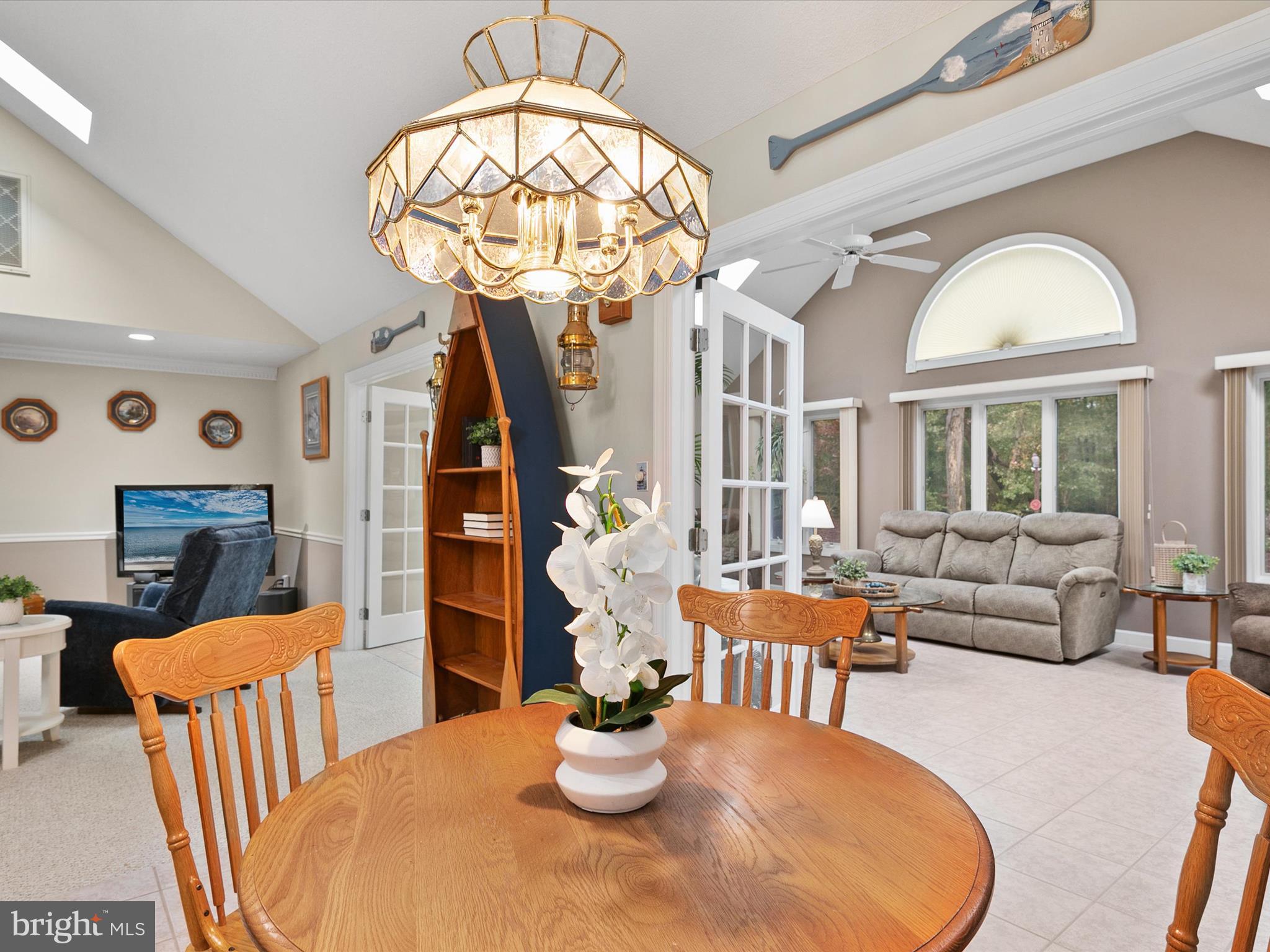 982 Turtle Drive Bethany Beach, DE 19930 - Photo 8 of 73 a dining room with furniture a chandelier and wooden floor